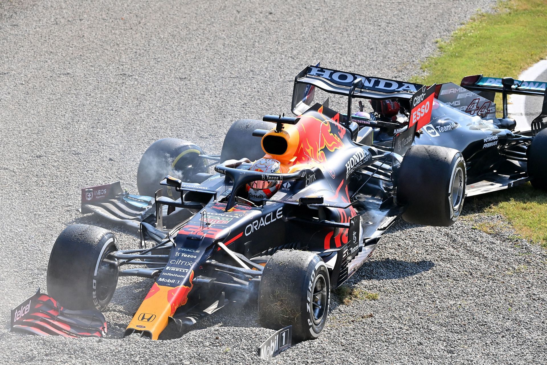 Max Verstappen of the Netherlands driving the (33) Red Bull Racing RB16B Honda and Lewis Hamilton of Great Britain driving the (44) Mercedes AMG Petronas F1 Team Mercedes W12 crash during the F1 Grand Prix of Italy at Autodromo di Monza - Source: Getty